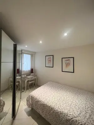 a bedroom with a bed and a desk in it at Sea view Croisette in Cannes