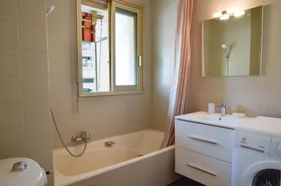 a bathroom with a tub and a sink and a bath tub at Palm Beach Studio with Terrace 150m from beaches in Cannes