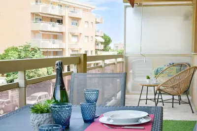 a table with a bottle of wine on a balcony at Palm Beach Studio with Terrace 150m from beaches in Cannes