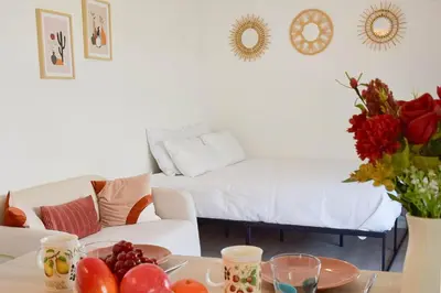 a living room with a couch and a table with fruit at Palm Beach Studio with Terrace 150m from beaches in Cannes