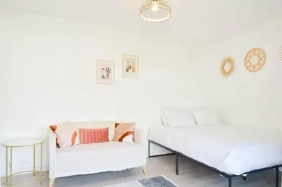 a living room with a couch and a bed at Palm Beach Studio with Terrace 150m from beaches in Cannes