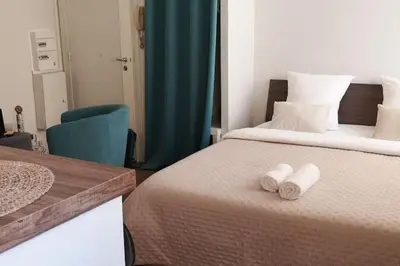 a bedroom with a bed with two towels on it at Un été à Cannes, Studio cosy à 10' de la Croisette in Cannes