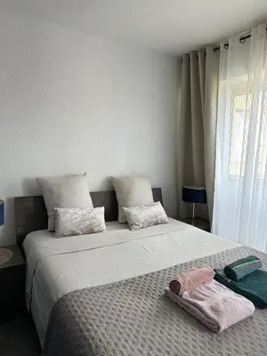a bedroom with a large bed with towels on it at Un été à Cannes, Studio cosy à 10' de la Croisette in Cannes