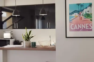 a kitchen with a counter top with a picture on the wall at Un été à Cannes, Studio cosy à 10' de la Croisette in Cannes