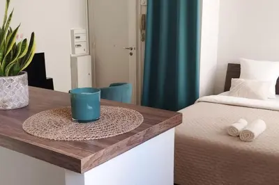 a table with a blue cup on top of a bed at Un été à Cannes, Studio cosy à 10' de la Croisette in Cannes