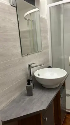 a bathroom with a white sink and a mirror at Appartement - Cannes proche Croisette avec jardin in Cannes