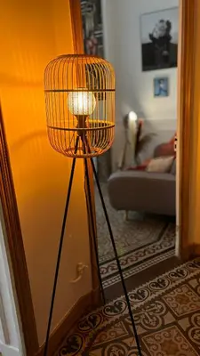 a wicker lamp in a living room next to a door at Appartement - Cannes proche Croisette avec jardin in Cannes