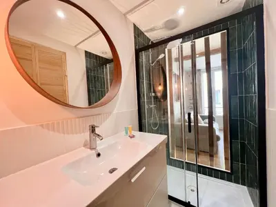a bathroom with a sink and a mirror at B066 Studio design à 5 mn de la plage in Cannes