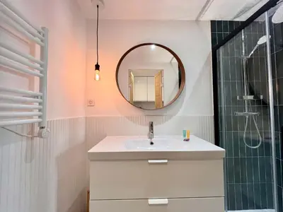 a bathroom with a sink and a mirror at B066 Studio design à 5 mn de la plage in Cannes