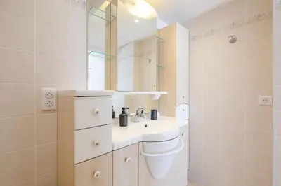 a bathroom with a sink and a mirror at Georges III - Apartment with panoramic view of Cannes in Cannes