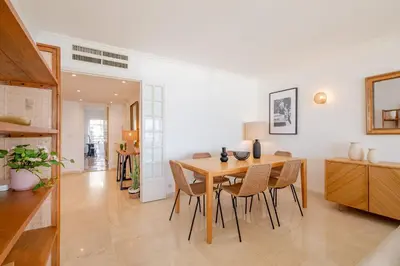 a kitchen and dining room with a table and chairs at Georges III - Apartment with panoramic view of Cannes in Cannes