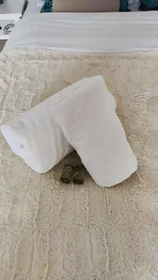 a pair of sandals are laying on a bed at Appartement Cannes Centre Proche de la Croisette! in Cannes