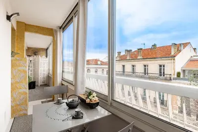 a room with a table and a large window at Appartement Cannes Centre Proche de la Croisette! in Cannes