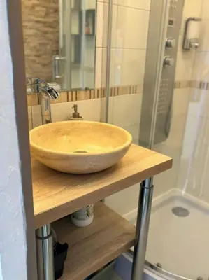 a bathroom with a bowl sink on a wooden counter at Cet été à Cannes, Studio cosy à 8' de la Croisette in Cannes
