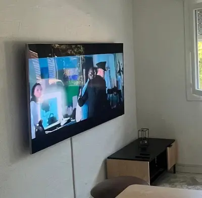 a flat screen tv hanging on a wall at Appartement studio Cannes in Cannes