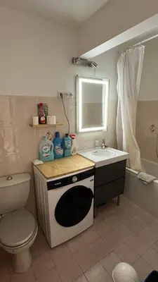 a small bathroom with a sink and a microwave at Appartement studio Cannes in Cannes