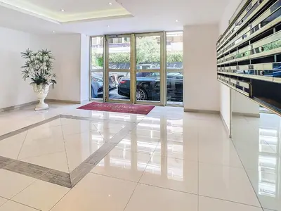 a living room with a table and a car garage at Beau 2 pièces proche Croisette avec parking 211 in Cannes