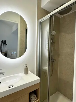 a bathroom with a sink and a shower at Charming appartement 3BR - 3BA - 3WC in Cannes