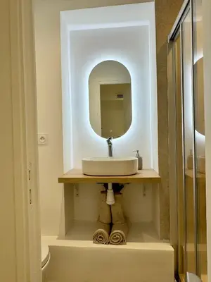 a bathroom with a sink and a mirror at Charming appartement 3BR - 3BA - 3WC in Cannes