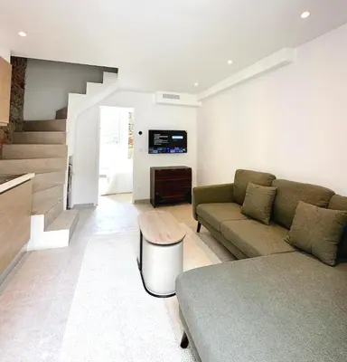 a living room with a couch and a tv at Charming appartement 3BR - 3BA - 3WC in Cannes