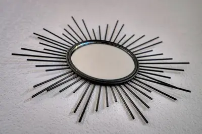a mirror on a wall with a starburstburst at Eva - Piscine - Terrasse - VCA in Cannes