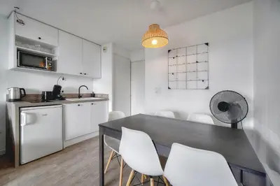 a kitchen and dining room with a table and chairs at Eva - Piscine - Terrasse - VCA in Cannes