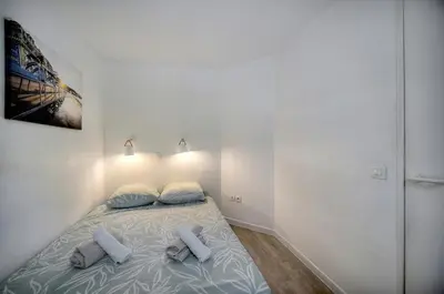 a bedroom with a bed with two pillows on it at Eva - Piscine - Terrasse - VCA in Cannes