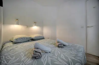 a bed with towels on it in a room at Eva - Piscine - Terrasse - VCA in Cannes