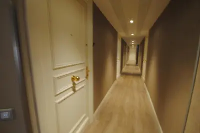 an empty hallway with a white door with a gold door knob at superbe appartement tout confort beg4012 in Cannes