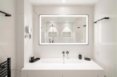 a white bathroom with a sink and a mirror at Charming oasis with terrace 4 BD- 8P - Cannes in Cannes