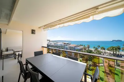 a balcony with a table and chairs and the ocean at Charming oasis with terrace 4 BD- 8P - Cannes in Cannes