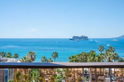a balcony with a view of the ocean and a cruise ship at Charming oasis with terrace 4 BD- 8P - Cannes in Cannes