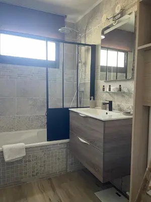 a bathroom with a tub and a sink at Riad by L'Oliveraie in Cannes