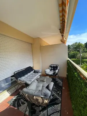 a balcony with a couch and two chairs on a patio at Riad by L'Oliveraie in Cannes