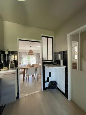 a kitchen with a table and a dining room at Riad by L'Oliveraie in Cannes