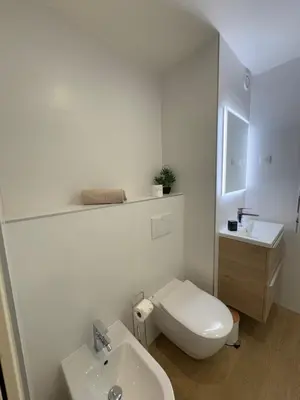 a white bathroom with a toilet and a sink at Le studio Palm Beach, Clim ,Parking, Neuf in Cannes
