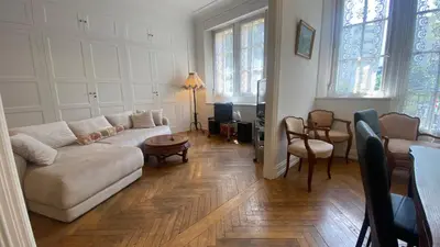 a living room with a couch and a table at Cannes - proche des plages de la célèbre Croisette in Cannes