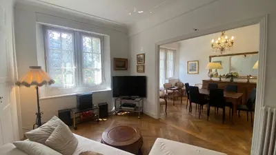 a living room with a table and a dining room at Cannes - proche des plages de la célèbre Croisette in Cannes