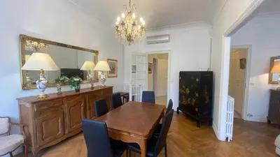 a dining room with a table and a mirror at Cannes - proche des plages de la célèbre Croisette in Cannes