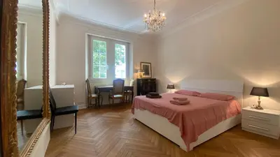 a bedroom with a bed and a desk in it at Cannes - proche des plages de la célèbre Croisette in Cannes