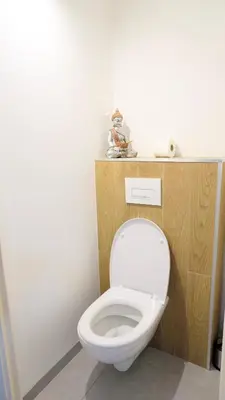 a bathroom with a white toilet in a room at Appartement 426, vue mer et piscine by Palmazur in Cannes