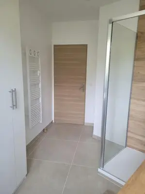 a bathroom with a shower and a tiled floor at Grand T2 vue mer dans résidence de standing, parking, pointe croisette in Cannes