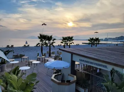 a view of a beach with tables and umbrellas at Grand T2 vue mer dans résidence de standing, parking, pointe croisette in Cannes