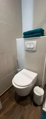 a bathroom with a white toilet in a room at Studio neuf avec terrasse in Cannes