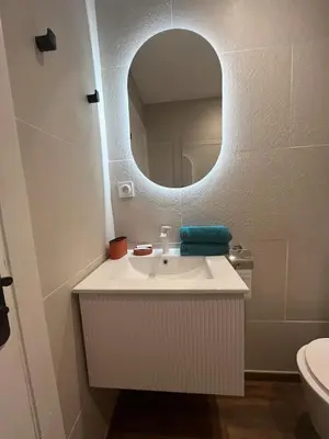 a bathroom with a white sink and a mirror at Studio neuf avec terrasse in Cannes