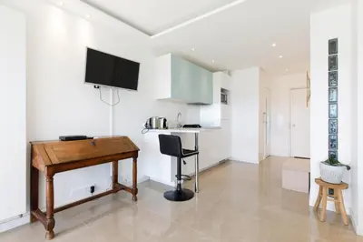 a kitchen with a desk and a table in a room at Cannes-vue mer Esterel-balcon-Plage in Cannes