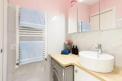 a bathroom with a sink and a washing machine at Cannes-vue mer Esterel-balcon-Plage in Cannes