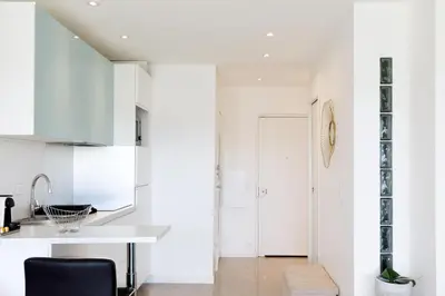 a kitchen with white walls and a white counter top at Cannes-vue mer Esterel-balcon-Plage in Cannes