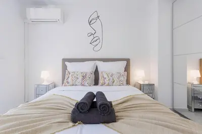 a bedroom with a bed with towels on it at Cannes Molière - Palais, Plage, Balcon, Clim et Centre ville in Cannes