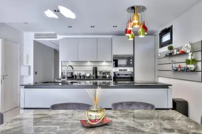 a kitchen with a table and chairs and a counter at Luxury 4 Stars Apt Croisette in Cannes
